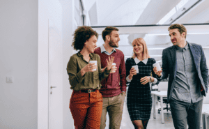 Four people walking while talking.
