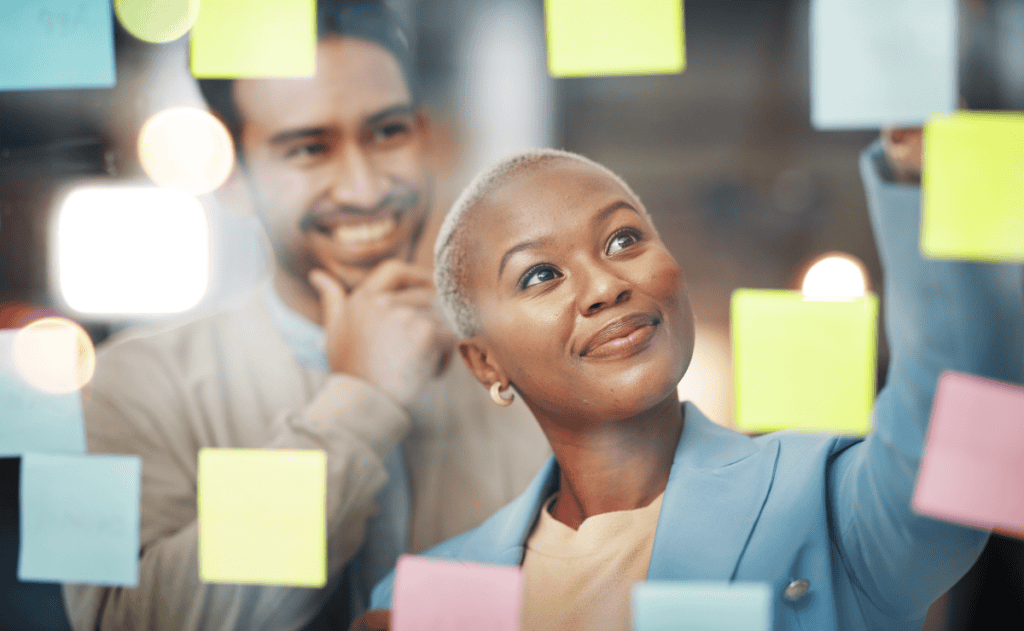 coworkers viewing sticky notes