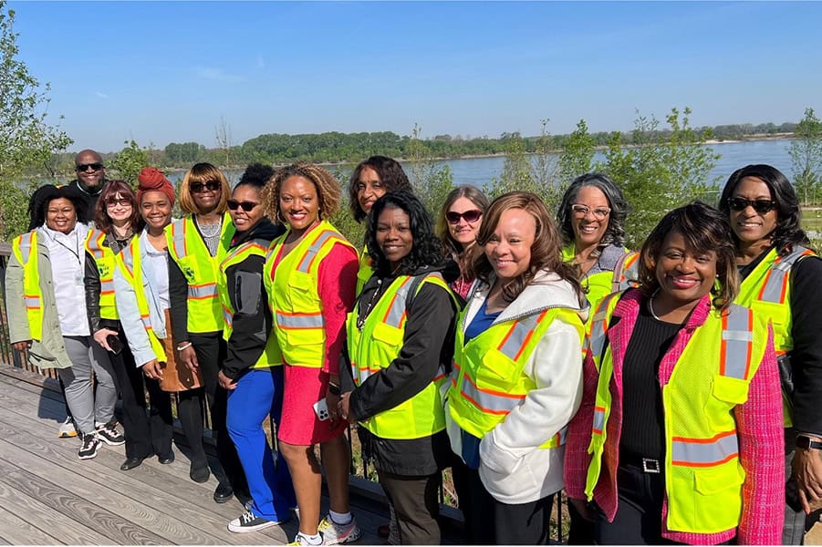 Shelby County health department director and employees wearing yellow vests standing outside