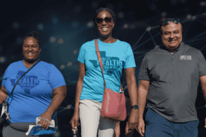 Three public health workers from Texas smiling and walking.