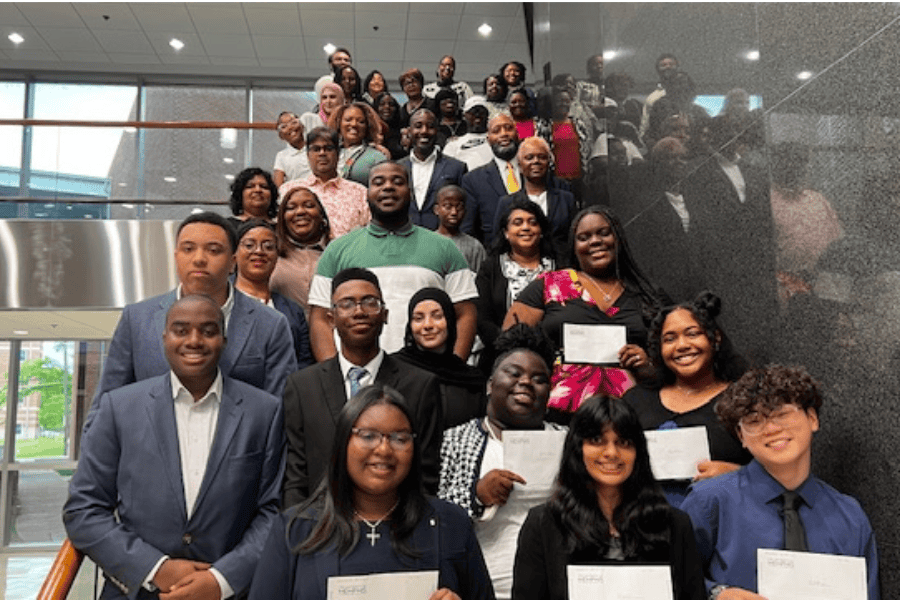 Student participants from Shelby County Health Department of Tennessee's Experiential Learning Program pose on the stairs holding their certificates.