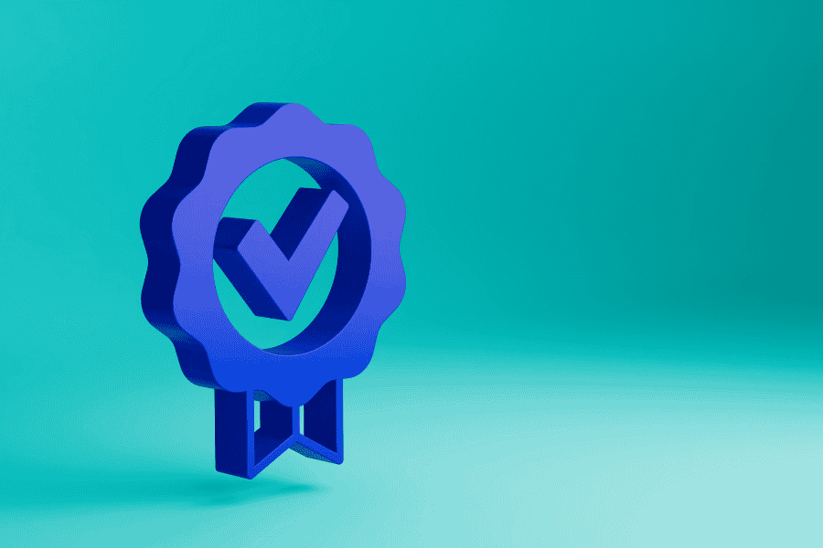 Blue badge featuring a check mark, set against a solid blue background, symbolizing verification or approval.