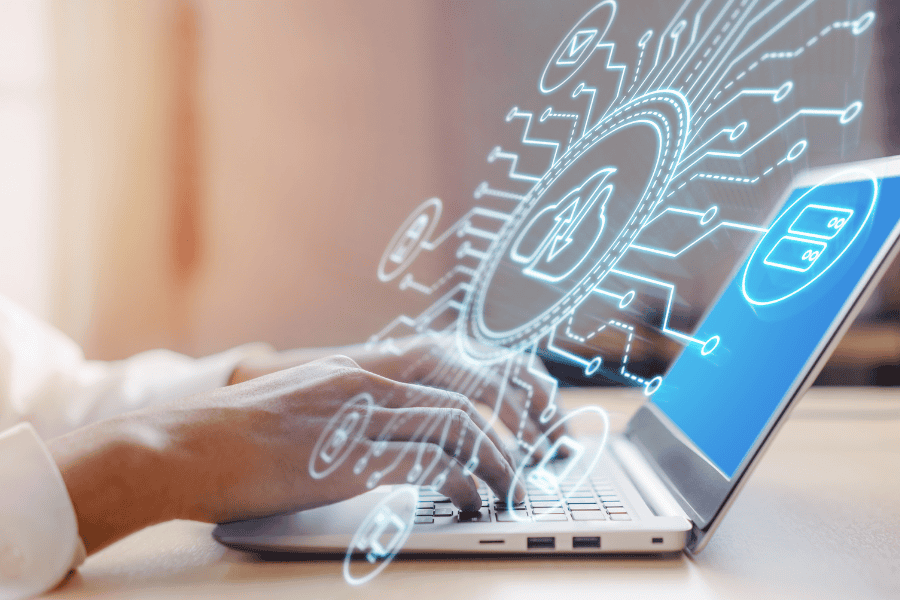 A person focused on a laptop displaying a cyber security icon, emphasizing digital safety and protection.