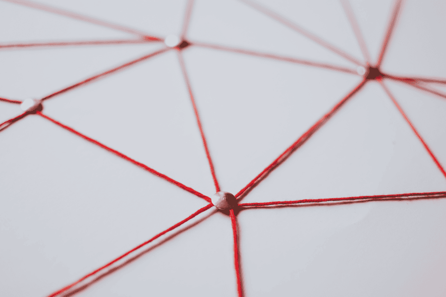 Gold pins connected by red strings.