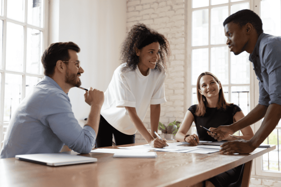 Four coworkers collaborating around a table.
