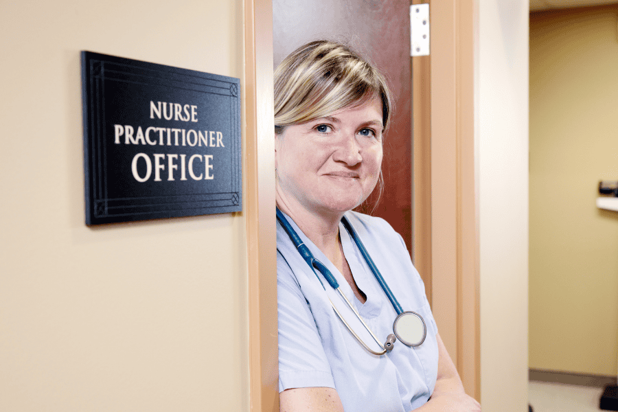 A nurse standing in her office doorway.