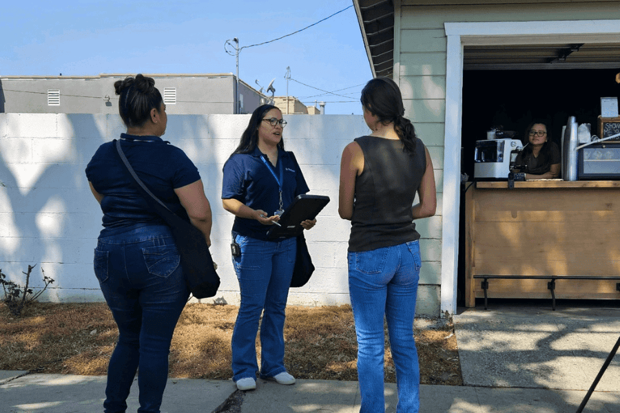 woman surveying two women on sidewalk