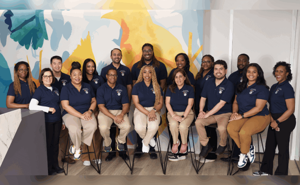 16 of ASTHO's 2025 DELPH Scholars in front of a colorful background