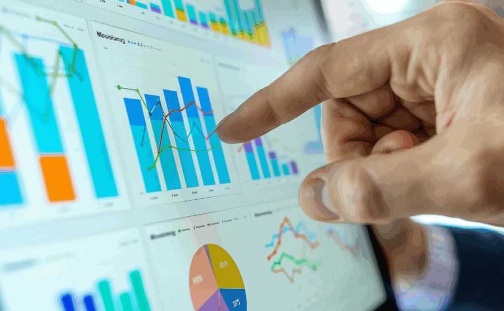 Hand pointing at data dashboards.