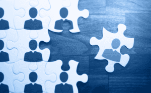 Conceptual image of icons of people on puzzle pieces.