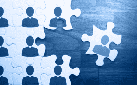 Conceptual image of icons of people on puzzle pieces.