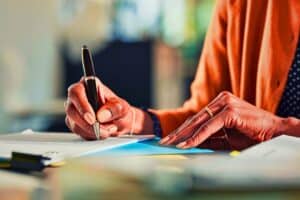Business woman's hands writing.