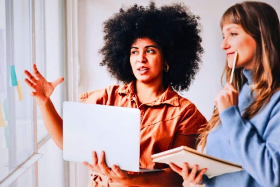 Two professional women strategizing.