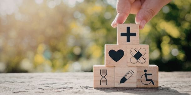 Building blocks on table with symbols relating to healthcare